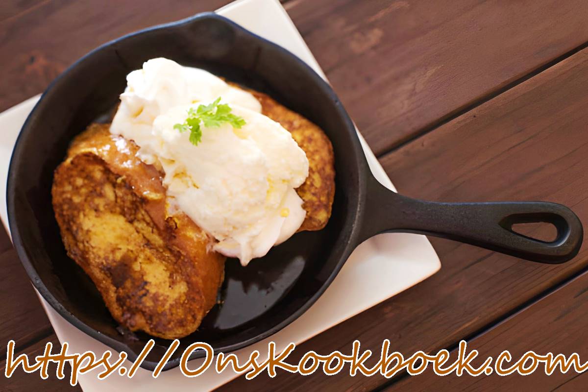 Goudbruin gewonnen brood met appel en speculaas in een pan, geserveerd met ijs