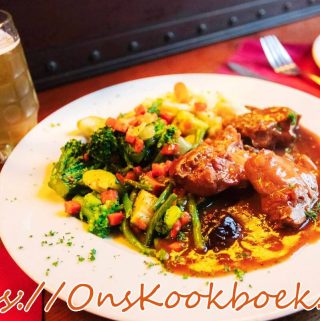 Konijn met pruimen en bier in Vlaamse saus, geserveerd met groenten en saus