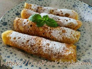 Luchtige flensjes, het klassieke pannenkoekenrecept van Jeroen Meus – dun gebakken en royaal bestrooid met bloemsuiker